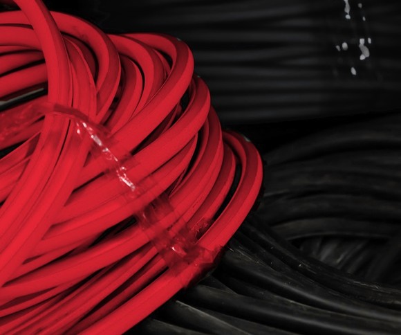 Coils of red and black single-core PVC cable