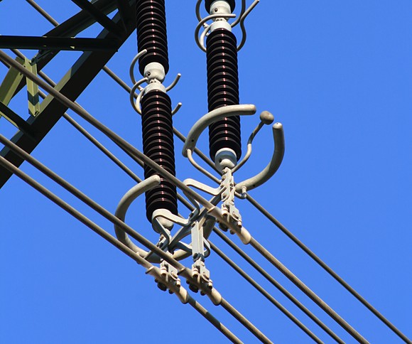 Suspension clamps and insulator strings on a high-voltage transmission tower